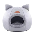 VELDR Cozy Cave Bed in light grey with a cat peeking out of the entrance