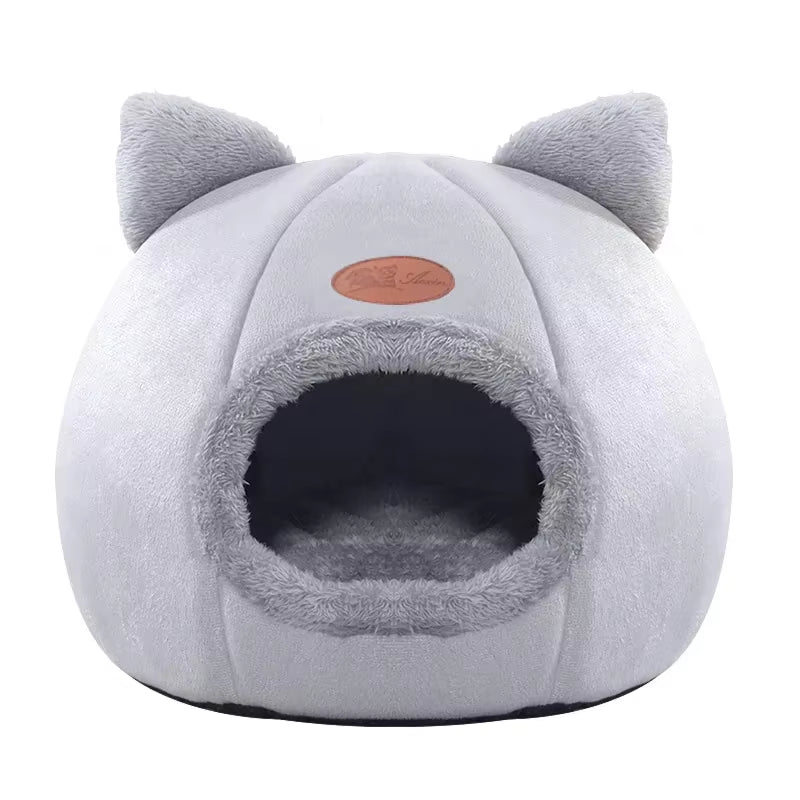 VELDR Cozy Cave Bed in light grey with a cat peeking out of the entrance